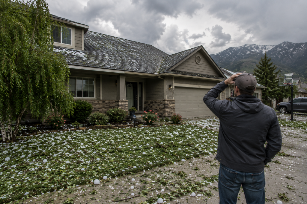 Colorado home after a hailstorm with debris in the yard