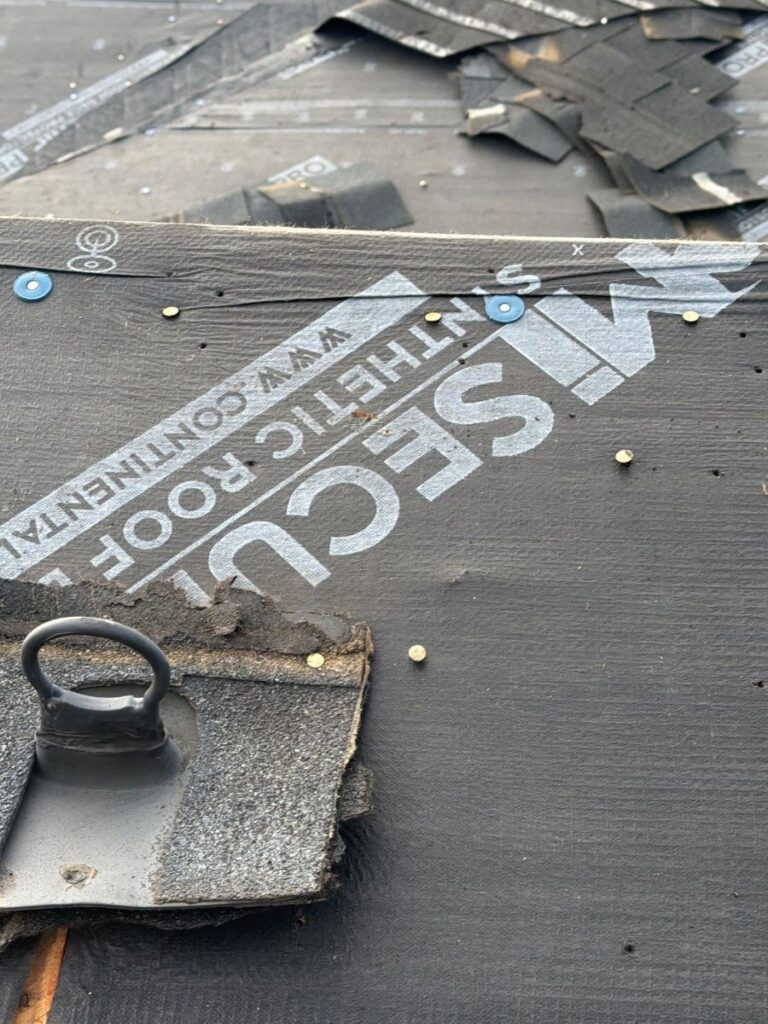 New synthetic underlayment going down during a Brighton roof replacement, October 2026